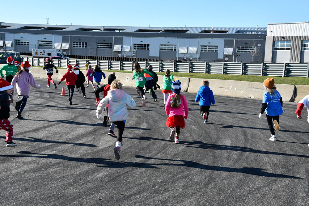 Kids in santa hats running on the track